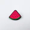 A slice of watermelon with a green rind and pink flesh with small black seeds.
