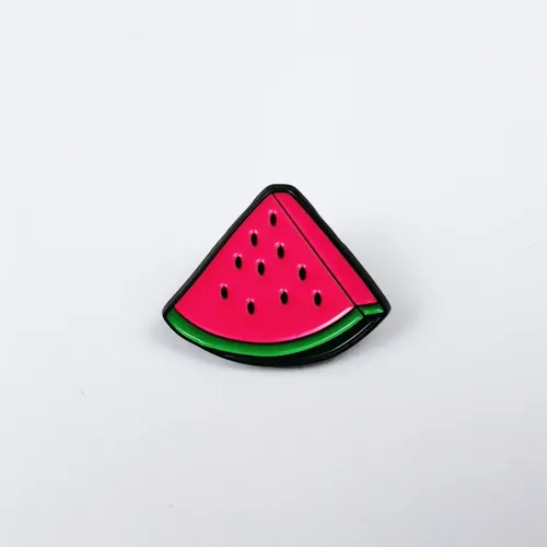 Watermelon Slice Pin Brooch - Free Palestine A slice of watermelon with a green rind and pink flesh with small black seeds.