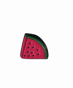 A watermelon slice-shaped enamel pin with black outlines, red interior, green rind, and small black seeds.