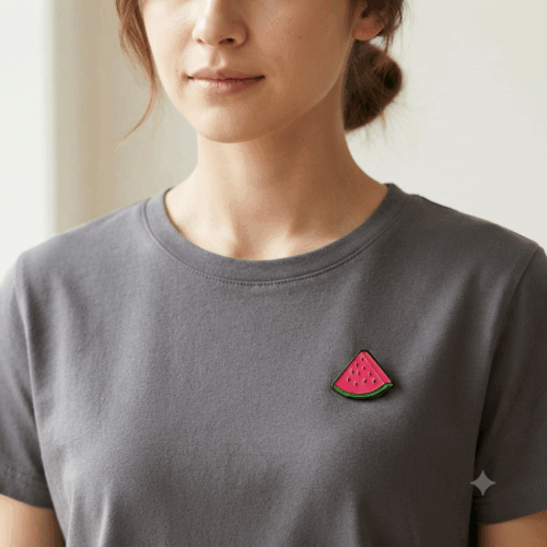 Watermelon Slice Pin Badge Palestine A Watermelon Slice Pin Badge worn on a female model on a short sleeve grey shirt