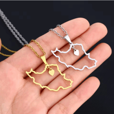 Iran Map Necklace in Silver and Gold Close up image showing details of the Iran Map Pendant Necklace in Silver and Gold, placed against a hand
